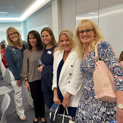 A group of women smiling at the camera.